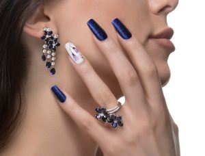 woman-with-nail-art-promoting-design-luxury-earrings-ring (1)